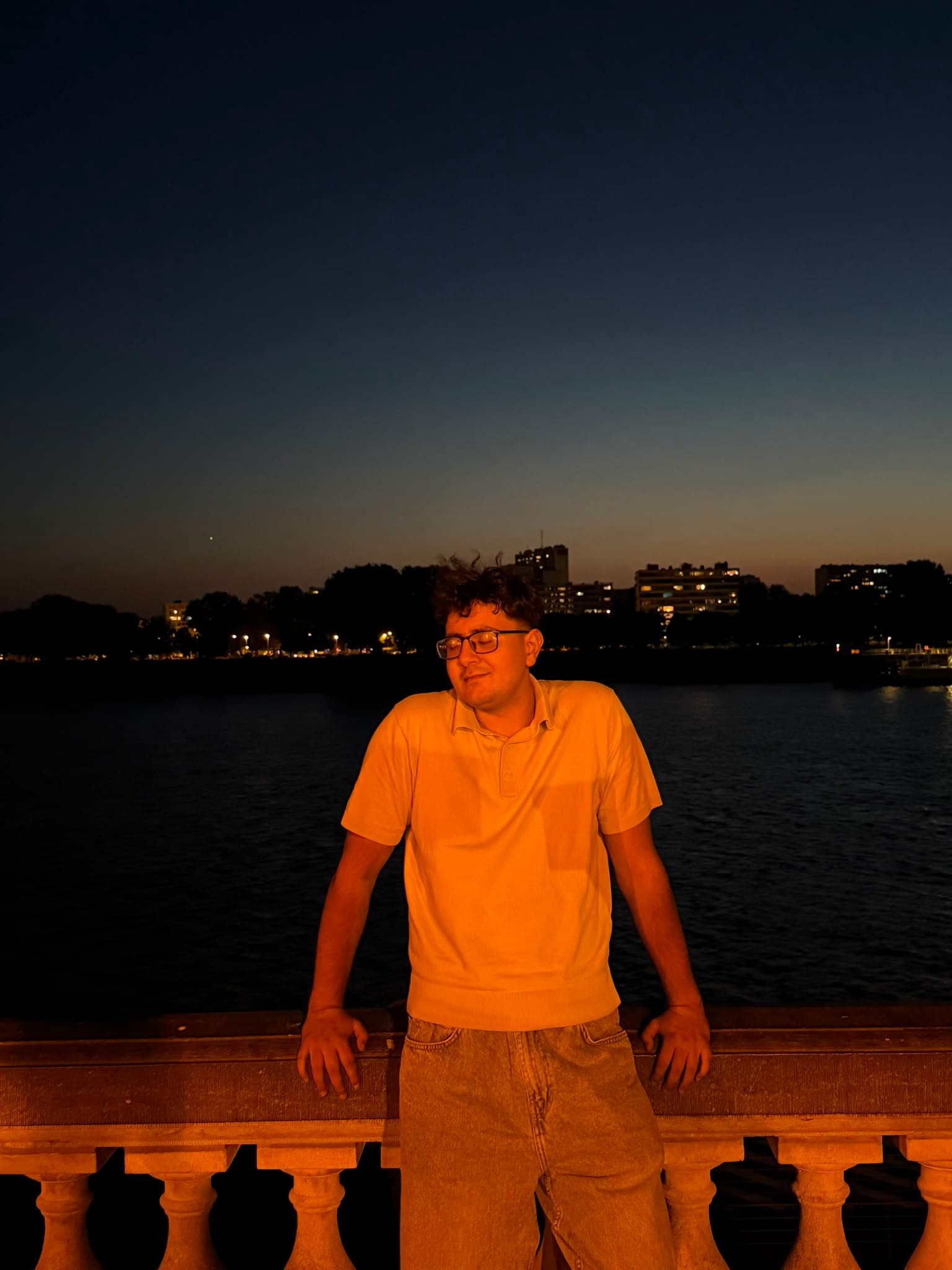 Omar beside the water at dusk